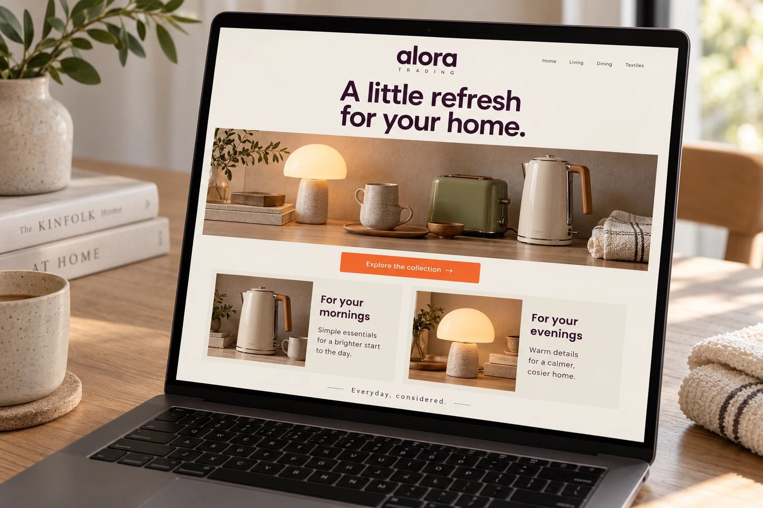 The Alora Trading website on a laptop, its home page headed “A little refresh for your home.” over a lamp, mugs, a green toaster and a kettle.