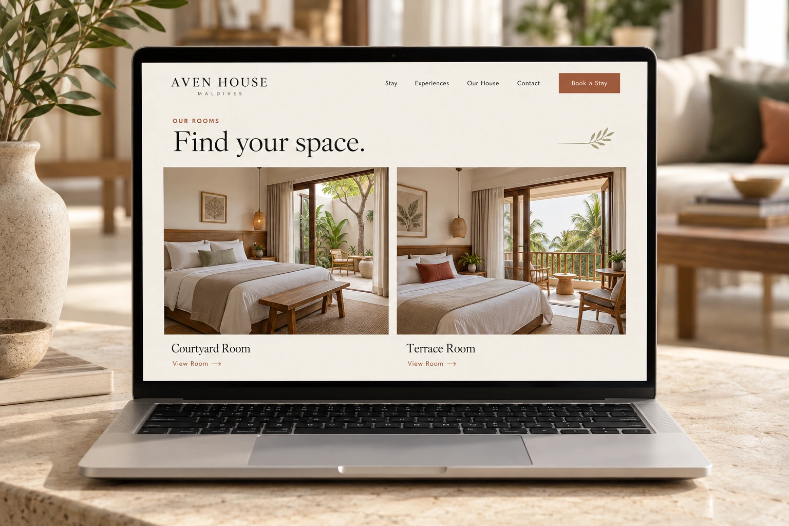 An Aven House rooms page on a laptop shows two bedrooms, the Courtyard Room and Terrace Room, under the heading “Find your space.” in black serif type.