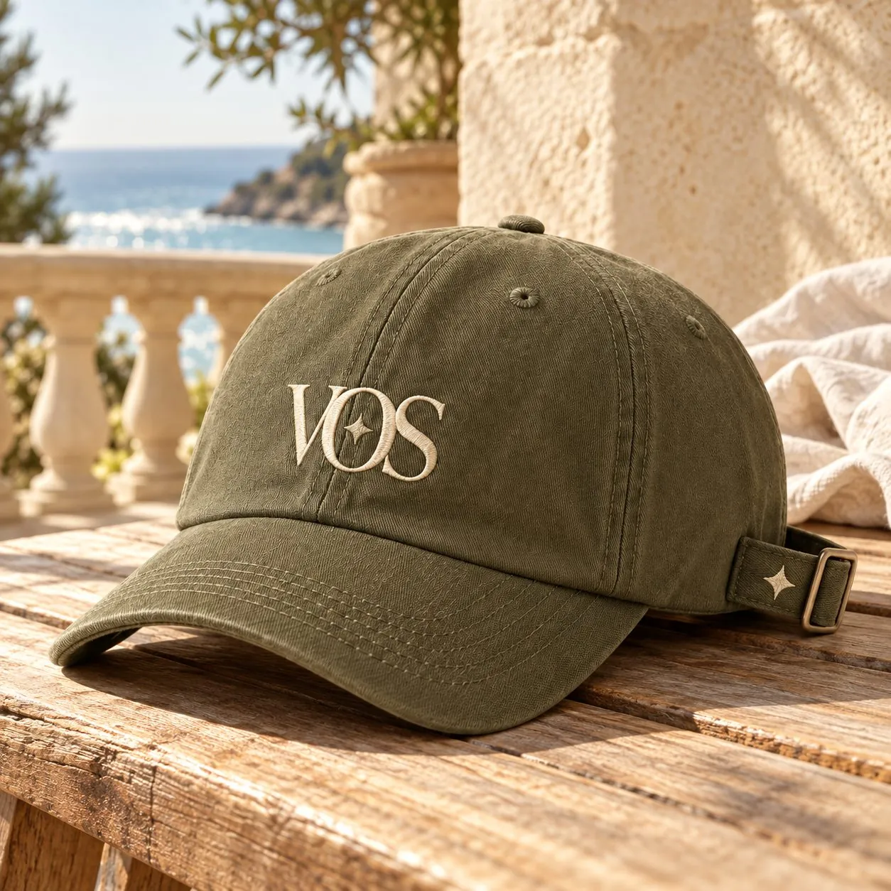 Olive Volume One Studio cap with the VOS monogram and its four-point star embroidered in cream.